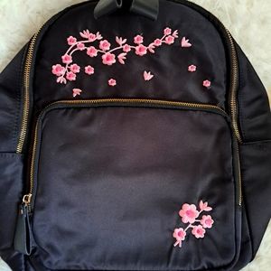 Black backpack with pink flowers.